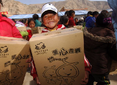 Student Zhoema holds a 'love package' at an orphans' school in quake-hit Yushu Tibetan Autonomous Prefecture of northwest China's Qinghai Province, on May 5, 2010. Each of 229 students of the school received a donated 'love package' including stationery and toy on Wednesday. 