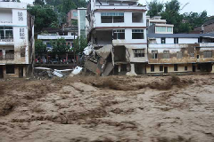 Floodwater rushes through the Wangmo county, Southwest China's Guizhou province, June 6, 2011. [Photo/Xinhua] 