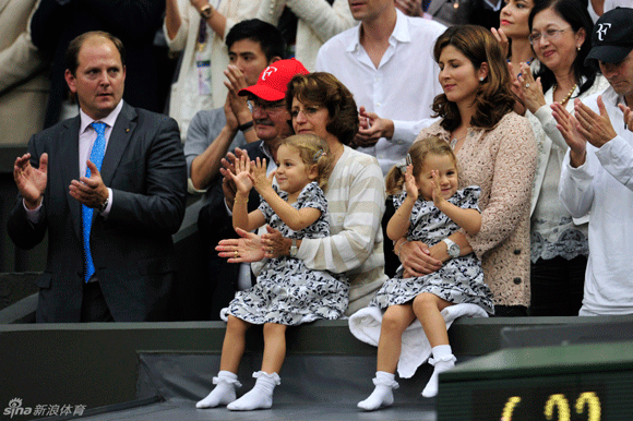 Federer's family watch on as he is presented with the trophy for a seventh time.
