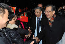 Chinese Premier Wen Jiabao (R, 1st) is greeted by representatives of overseas Chinese and Chinese students studying in Denmark after his special plane arrived in Copenhagen, December 16, 2009