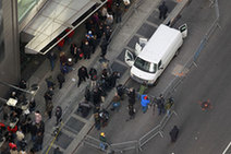 Members of the media and pedestrians inspect a van that has been declared a "suspicious vehicle" near Times Square in New York December 30, 2009.