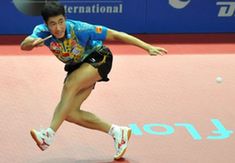 Wang Liqin of China returns the ball to his compatriot Xu Xin during the men's singles semifinal at the International Table Tennis Federation (ITTF) Pro Tour Grand Finals in Macao, south China, on Jan. 10, 2010. Wang lost the match 2-4. (Xinhua/Lo Ping Fai)  