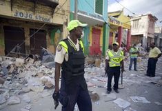 Haitian police patrol at a street in Haitian capital Port-au-Prince on Jan. 16, 2010. The situation in Haiti is worsened by occasional looting in the aftermath of a devastating earthquake on Jan. 12. (Xinhua/David de la Paz)