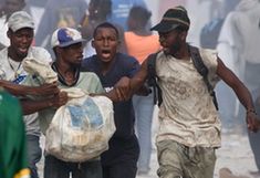  Looters fight for a bag of materials in Haitian capital Port-au-Prince on Jan. 16, 2010. The situation in Haiti is worsened by occasional looting in the aftermath of a devastating earthquake on Jan. 12. (Xinhua/David de la Paz)