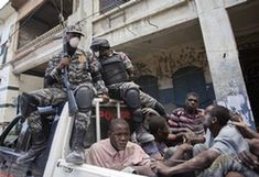 Haitian police arrest suspected looters in Haitian capital Port-au-Prince on Jan. 16, 2010. The situation in Haiti is worsened by occasional looting in the aftermath of a devastating earthquake on Jan. 12. (Xinhua/David de la Paz)