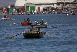 Local citizens try to flee this destroyed city by boat in Port-au-Prince, Haiti, Jan. 20, 2010. A 7.0 magnitude earthquake hit the country on Jan. 12, 2010. (Xinhua/David de la Pas)