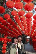 A young pair enjoy the sightseeing of the long corridor decorated with full range of florid red lanterns inside the Ditan (Altar of the Earth) Park, as the festival atmosphere for the 25th Spring Festival Temple Fair, slated from February 13 to 20, at Ditan Park is drumming up, in Beijing, February 4, 2010. A young pair enjoy the sightseeing of the long corridor decorated with full range of florid red lanterns inside the Ditan (Altar of the Earth) Park, as the festival atmosphere for the 25th Spring Festival Temple Fair, slated from February 13 to 20, at Ditan Park is drumming up, in Beijing, February 4, 2010.