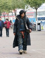 An undated photograph of a homeless man, nicknamed Brother Sharp for his good looks and sharp dress sense, wandering the streets of Ningbo, Zhejiang province, was recently posted on the Internet. He is one of the most talked about personalities in Chinese cyberspace today. [www.tianya.cn]