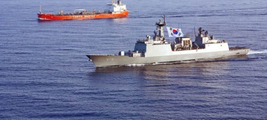 In this file photo a South Korean DDH-975 destroyer escort a cargo ship.