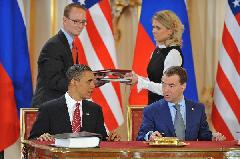 U.S. President Barack Obama (L) and his Russian counterpart Dmitry Medvedev sign a landmark nuclear arms reduction treaty in Prague, capital of Czech Republic, on April 8, 2010. Under the new pact, the two countries agreed to reduce their deployed nuclear warheads to 1,550 each, or 30 percent below the current level of 2,200, and cut the launchers below 700 each.[Wu Wei/Xinhua]