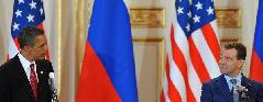 U.S. President Barack Obama (L) and his Russian counterpart Dmitry Medvedev attend a news conference after signing a landmark nuclear arms reduction treaty in Prague, capital of Czech Republic, on April 8, 2010. Under the new pact, the two countries agreed to reduce their deployed nuclear warheads to 1,550 each, or 30 percent below the current level of 2,200, and cut the launchers below 700 each.[Wu Wei/Xinhua]