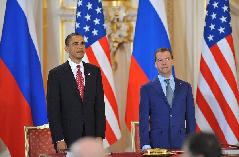 U.S. President Barack Obama (L) and his Russian counterpart Dmitry Medvedev prepare to sign a landmark nuclear arms reduction treaty in Prague, capital of Czech Republic, on April 8, 2010. Under the new pact, the two countries agreed to reduce their deployed nuclear warheads to 1,550 each, or 30 percent below the current level of 2,200, and cut the launchers below 700 each.[Wu Wei/Xinhua]
