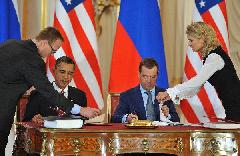 U.S. President Barack Obama (L) and his Russian counterpart Dmitry Medvedev sign a landmark nuclear arms reduction treaty in Prague, capital of Czech Republic, on April 8, 2010. Under the new pact, the two countries agreed to reduce their deployed nuclear warheads to 1,550 each, or 30 percent below the current level of 2,200, and cut the launchers below 700 each.[Wu Wei/Xinhua]