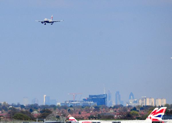 An airplane of British Airways is about to land at the Heathrow Airport in London, capital of Britain, April 21, 2010. The British authority reopened its airspace from 10:00 p.m. on Tuesday, which had been shut down since April 15 owing to the influence of volcanic ash from Iceland. [Zeng Yi/Xinhua]
