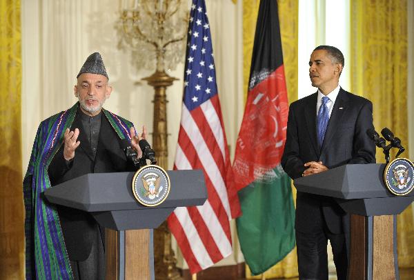 U.S. President Barack Obama (R) and visiting Afghan President Hamid Karzai attend a joint press conference after their meeting at the East Room of the White House in Washington D.C., capital of the United States, May 12, 2010. [Zhang Jun/Xinhua]