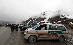 An ambulance is on standby near the mountains where an Afghan Pamir Airways plane is believed to have crashed in the Salang pass May 17, 2010. A passenger airplane crashed Monday enroute from Afghanistan's northern city of Kunduz to capital city of Kabul with 43 on board, Afghan officials told Xinhua.