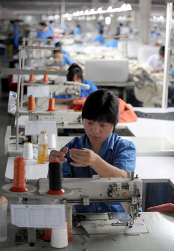 Zhao Jinzhi is on the production line at a sofa manufacturer in Hangzhou, East China's Zhejiang province, May 25, 2010. Together with her husband, Xu Yuwang, Zhao, a post-80s woman from Henan province, was recruited to the factory three years ago as a needle worker with a monthly income of 1,200 yuan, while Xu, a slipcover maker, made 3,000 yuan per month. 