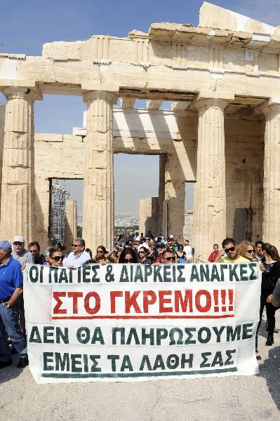 Greek protestors hold a banner with 'Our needs are thrown down the cliff. We will not pay for their mistakes' during an inspection by Greek President Karolos Papoulias on the Acropolis Hill in Athens, Greece, on May 25, 2010. The short-term contract employees demanded back pay and more job positions. (Xinhua/Phasma) Greek protestors hold a banner with 'Our needs are thrown down the cliff. We will not pay for their mistakes' during an inspection by Greek President Karolos Papoulias on the Acropolis Hill in Athens, Greece, on May 25, 2010. The short-term contract employees demanded back pay and more job positions. (Xinhua/Phasma)