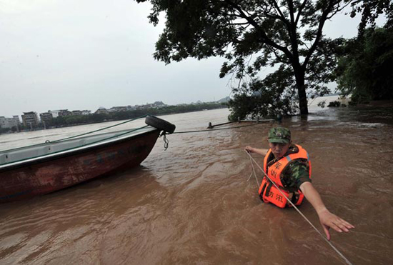 A rescuer works on a flooded street in Guilin, southwest China's Guangxi Zhuang Autonomous Region, June 17, 2010. A rescuer works on a flooded street in Guilin, southwest China's Guangxi Zhuang Autonomous Region, June 17, 2010.