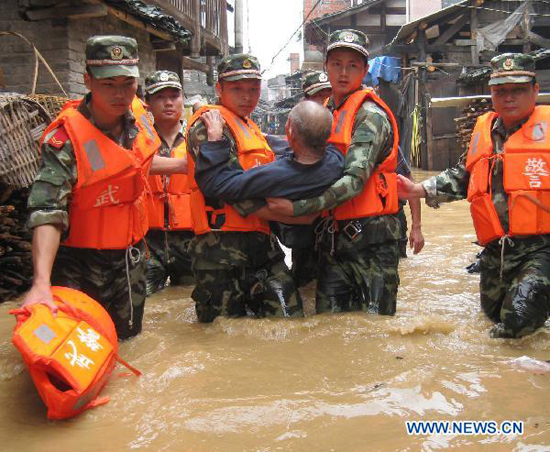 Soldiers transfer an old man trapped by the flood water at Songxi Town of Qingliu County, southeast China's Fujian Province, June 18, 2010. Soldiers transfer an old man trapped by the flood water at Songxi Town of Qingliu County, southeast China's Fujian Province, June 18, 2010.