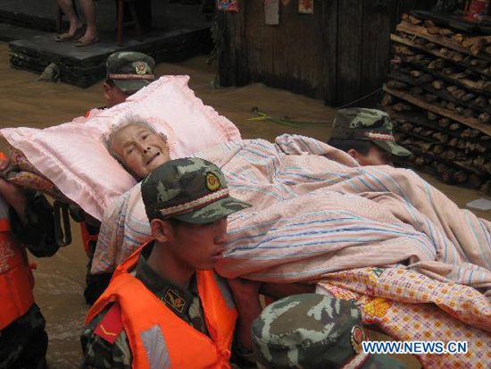 Soldiers transfer an old woman trapped by the flood water at Songxi Town of Qingliu County, southeast China's Fujian Province, June 18, 2010. Soldiers transfer an old woman trapped by the flood water at Songxi Town of Qingliu County, southeast China's Fujian Province, June 18, 2010.