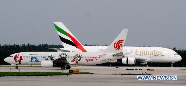 Emirates Airlines&apos; A380 passenger plane (R) of the United Arab Emirates (UAE) arrives at the Capital International Airport in Beijing, capital of China, on Aug. 1, 2010. Emirates Airlines launched its first A380 service in China, flight EK306/307 between Dubai and Beijing on Sunday. [Xinhua]