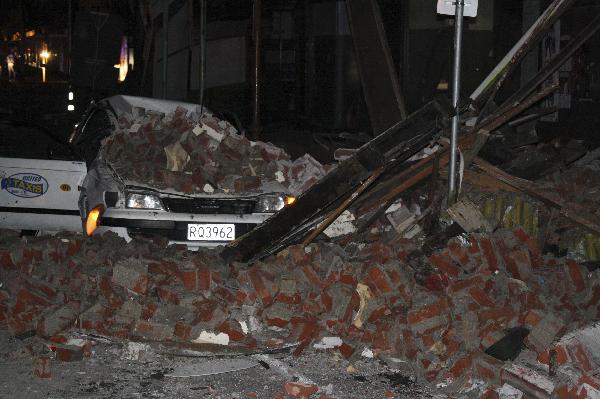 A car lies under fallen rubble in Christchurch, New Zealand after a powerful earthquake struck much of New Zealand's South Island early Saturday Sept. 4, 2010. [Xinhua]