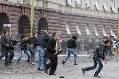 Protesters throw stones at police in Tirana, Albania, Jan. 21, 2011. Two people were killed from firearms after a protest rally by Albania's opposition Socialist Party turned into a riot in front of the government building for three hours before the protesters disbanded. [Yang Ke/Xinhua]