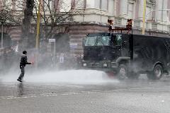 Police use water cannon to disperse protesters outside the prime minister's office in Tirana, Albania, Jan. 21, 2011. Two people were killed from firearms after a protest rally by Albania's opposition Socialist Party turned into a riot in front of the government building for three hours before the protesters disbanded. [Yang Ke/Xinhua]