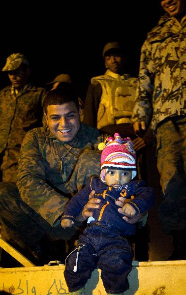 A child poses for photos in front of a tank as people celebrate the resignation of Egyptian President Hosni Mubarak on Tahrir Square in Cairo, Egypt, Feb. 11, 2011. Egypt's President Hosni Mubarak steps down and the military take charge of the country, Egypt's Vice President Omar Suleiman said on Friday afternoon. A child poses for photos in front of a tank as people celebrate the resignation of Egyptian President Hosni Mubarak on Tahrir Square in Cairo, Egypt, Feb. 11, 2011. Egypt's President Hosni Mubarak steps down and the military take charge of the country, Egypt's Vice President Omar Suleiman said on Friday afternoon.
