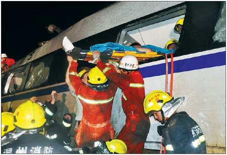  A survivor is removed from the wreckage of a passenger train carriage on Saturday night in Zhejiang province.