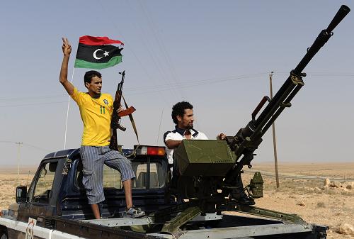 NTC fighters secure a new check point on the road between Tarhuna to Bani Walid, southeast of Tripoli, on September 4, 2011, as fighters loyal to Libya's new rulers advanced on one of Moamer Kadhafi's last remaining bastions. [Xinhua]