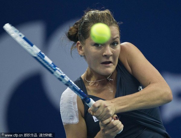 Poland's Agnieszka Radwanska returns the ball to Flavia Pennetta of Italy in their singles semifinal match of the China Open Tennis Tournament in Beijing, Saturday, Oct. 8, 2011.