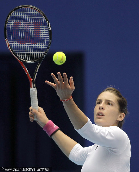 Germany's Andrea Petkovic eyes the ball as she plays with Monica Niculescu of Romania in their singles semifinal match of the China Open Tennis Tournament in Beijing, Saturday, Oct. 8, 2011.