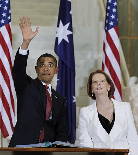 U.S. President Barack Obama waves to the public inside Parliament House as Australian Prime Minister Julia Gillard looks on in Canberra on November 16, 2011.[Xinhua] 