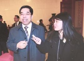 Ma Jiantang (L), head of the National Bureau of Statistics, is interviewed on the sidelines of the National People's Congress in Beijing. 