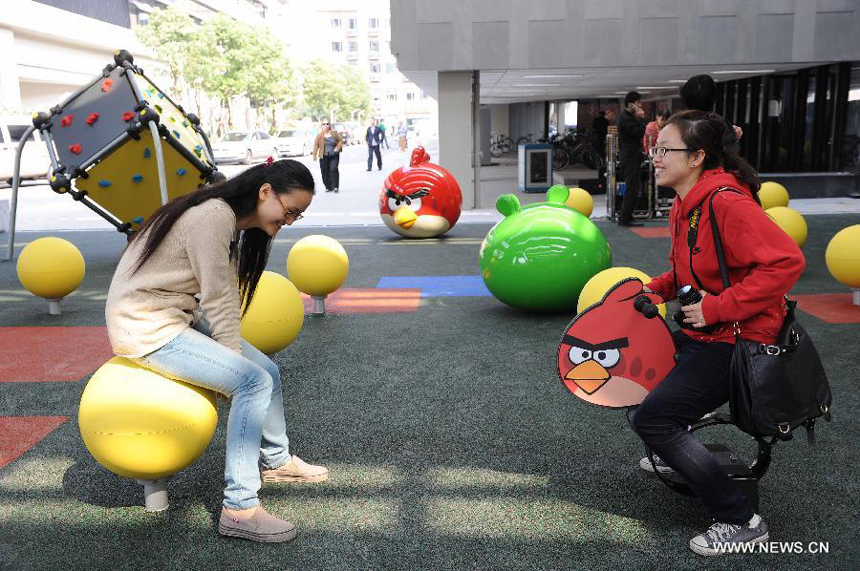 Visitors play at an Angry Birds outdoor theme park in Shanghai, east China, Oct. 31, 2012. The theme park, which is located in Tongji University, covers an area of about 200 square meters. 