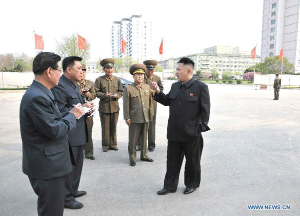The photo provided by KCNA on May 7, 2013 shows top leader of the Democratic People's Republic of Korea (DPRK) Kim Jong Un (1st R) inspecting construction projects built by Korean People's Army on May 6, 2013. 