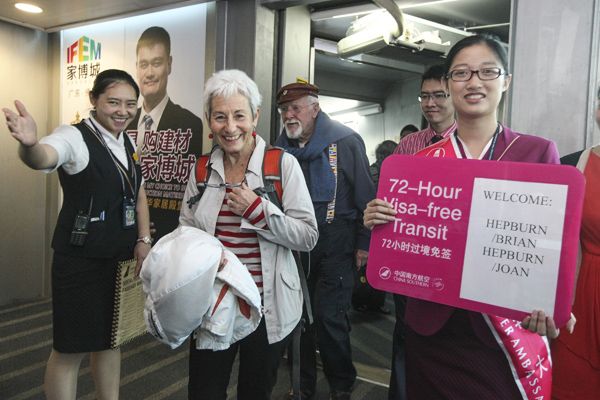 Joan Hepburn and her husband Brian, from New Zealand, become the first foreigners landing at Guangzhou Baiyun International Airport to benefit from the city's 72-hour visa-free policy on Thursday.