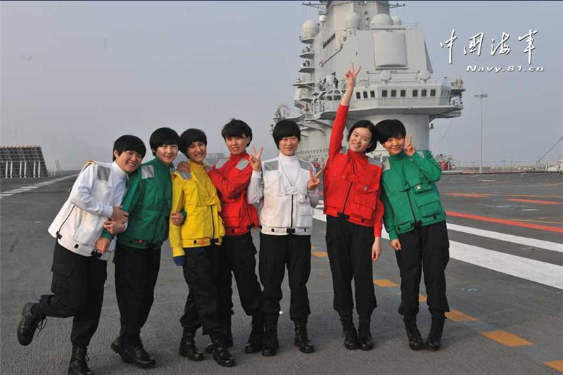 A small group of female trainees pose for a photo on board Liaoning. [Photo/navy.81.cn]